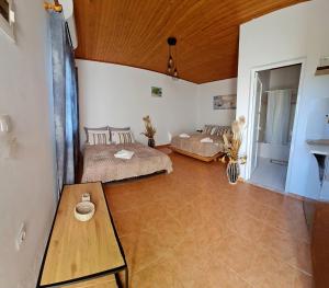 a large room with two beds and a wooden ceiling at Pefkos Sea Shell in Pefki