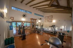 a gym with several treadmills and exercise bikes in a room at Pousada Quinta do Bucanero in Imbituba