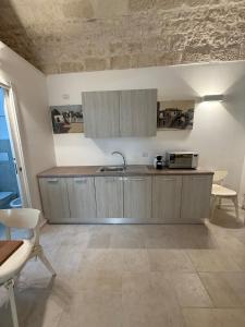 a kitchen with a sink and a counter at Neptune Stone House in Molfetta