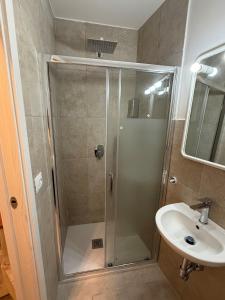 a bathroom with a shower and a sink at Neptune Stone House in Molfetta