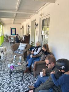 a group of people sitting on couches in a living room at Greyton Toad Hall in Greyton