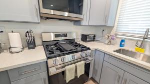 a kitchen with a stove top oven next to a sink at Rest Haven Motel in Los Angeles