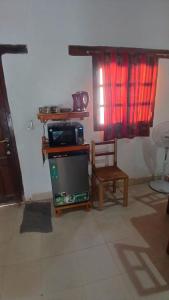 a living room with a tv and a chair at hospedaje chango luna in Purmamarca