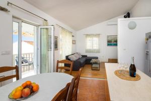 a living room with a table with fruit on it at Apartmani Darijo in Čelina