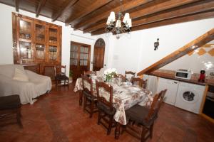 a dining room with a table and a kitchen at Casa Teones con piscina privada in Montecorto