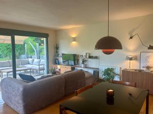 a living room with a couch and a table at Casa Libao-VILLA ENTRE BILBAO Y URDAIBAI CON PISCINA PRIVADA in Arrieta