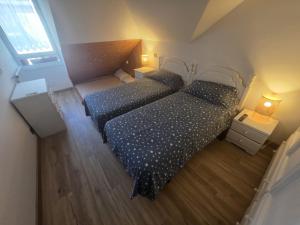 an overhead view of two beds in a room at Atico in Noja Helgueras in Noja