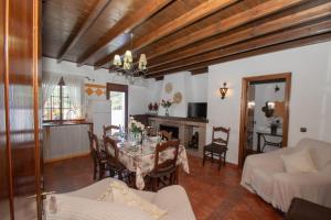 a living room with a table and a dining room at Casa Teones con piscina privada in Montecorto