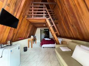 a living room with a staircase in a room at Complexo Turístico Canaã in Nobres