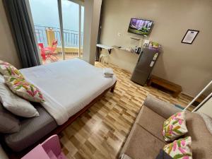 a bedroom with a bed and a television in a room at Aizawl Hotel in Āīzawl