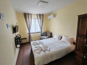 a bedroom with a bed with a bow on it at Guesthouse Oasis-Shabla in Shabla