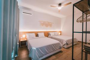 two beds in a room with two bunk beds at Casa Jardim di Sol in Praia +61 photos