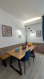 a dining room with a wooden table and chairs at L'Atelier du Quai in Mâcon