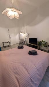 a bedroom with a large bed with two pillows on it at L'Atelier du Quai in Mâcon