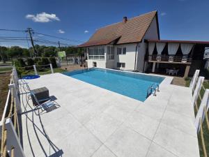 a swimming pool in front of a house at Casa Deac in Sebeş