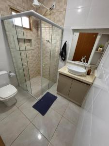 a bathroom with a shower and a toilet and a sink at Sitio em São Pedro de Alcantara in São Pedro de Alcântara