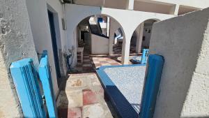 an entrance to a building with blue poles in front at Small Apartments Rooms Only in Perissa +3 photos