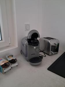 a kitchen counter with a printer and a toaster at l'annexe in Le Givre +6 photos