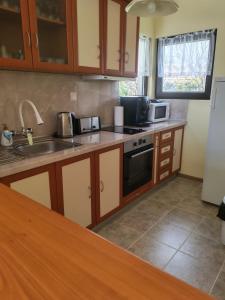 a kitchen with a sink and a stove top oven at Guesthouse Oasis-Shabla in Shabla