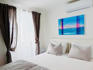 a bedroom with a bed with white sheets and a window at Charming Casa Maria Pag in Pag +32 photos