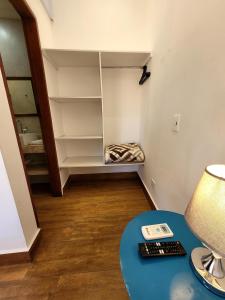 a room with a book shelf and a table with a lamp at Pousada Casa Hospedaria in Paraty +41 photos