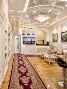 a living room with a red rug on the floor at White House SPA Hotel in Baku