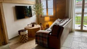a living room with a couch and a table at Black Cockatoo Lodge close to Bern and Thun in Oberdiessbach