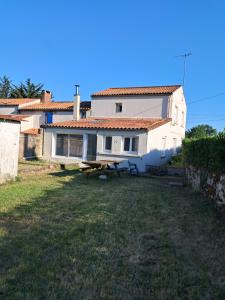 a house with a picnic table in front of it at l'annexe in Le Givre