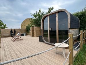 a wooden deck with a circular building with a rope at Jimmy's Yurt in Shenley