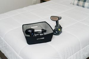 a box with a gaming system on a bed at Casa Othir in Monterrey