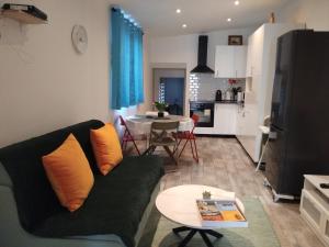 a living room with a couch and a table at Iglu in Villeneuve-le-Roi