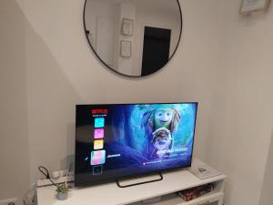 a flat screen tv sitting on top of a table at Iglu in Villeneuve-le-Roi