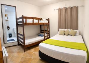 a bedroom with two bunk beds and a mirror at Pousada Wilclé Center Preá in Prea