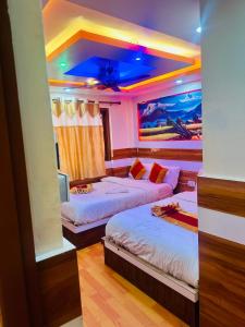 a bedroom with two beds and a painting on the ceiling at pokhara hotel Kathmandu pvt ltd in Kathmandu