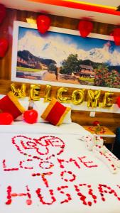 a room with a bed with a sign that says happy anniversary at pokhara hotel Kathmandu pvt ltd in Kathmandu