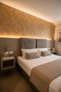 a bedroom with a large bed with two pillows at Boutique Hotel Roma 30 in Trescore Balneario +17 photos