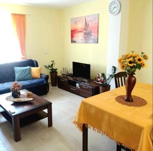 a living room with a blue couch and a table at Apartment Tamara in Tivat