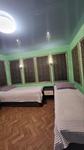 a room with two beds in a room with windows at Vintage in Kotowsk