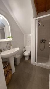 a white bathroom with a sink and a toilet at Paraga Meltemi View in Platis Gialos +23 photos