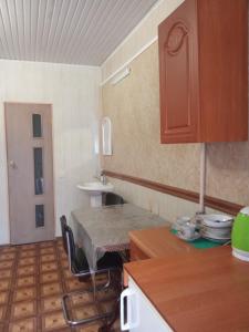a small kitchen with a table and a sink at Vintage in Kotowsk
