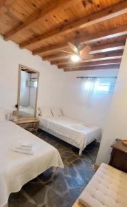 a room with two beds and a mirror at Paraga Meltemi View in Platis Gialos