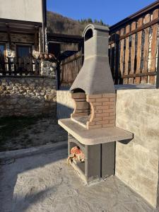 a brick oven sitting outside of a house at Villa Vera in Smilyan