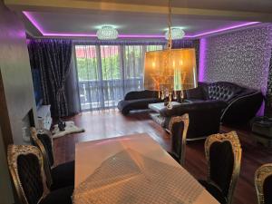 a living room with purple lighting and a table and chairs at PIOTROWSKi HOUSE in Ropica Górna +54 photos