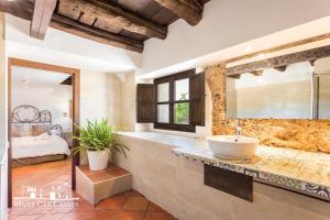 a bathroom with a tub, sink, and toilet at Masia Can Canyes & Spa in San Lorenzo de Hortóns