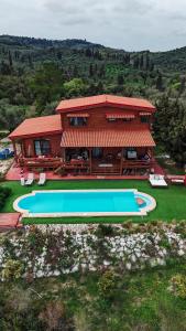 a house with a swimming pool in front of it at The Lodge apartment in Mesongi