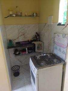 a kitchen with a stove top oven in a room at Recanto Jane e Daniel in Angra dos Reis +22 photos