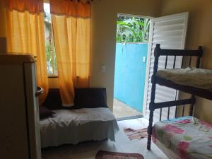 a bedroom with two bunk beds and a door to a porch at Recanto Jane e Daniel in Angra dos Reis
