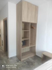 a wooden cabinet in the corner of a room at Matina Studios in Kefalos
