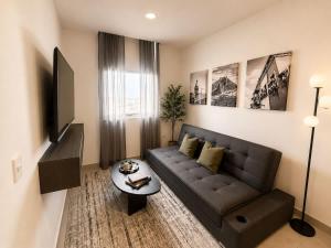 a living room with a couch and a table at FIFA Monterrey Stay in Monterrey
