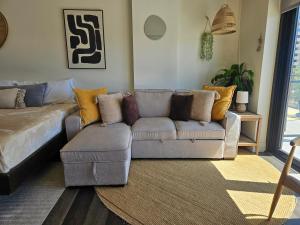 a living room with a couch and a chair at Cherry Creek Rooftop Oasis in Denver +27 photos